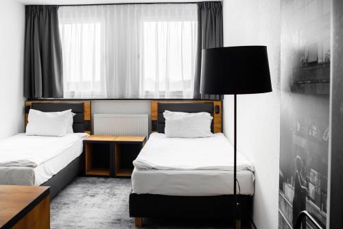 Ένα ή περισσότερα κρεβάτια σε δωμάτιο στο Mercure Opole