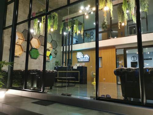 a view of a lobby with windows and chairs at Thanks​Pama​ in Bang Khen