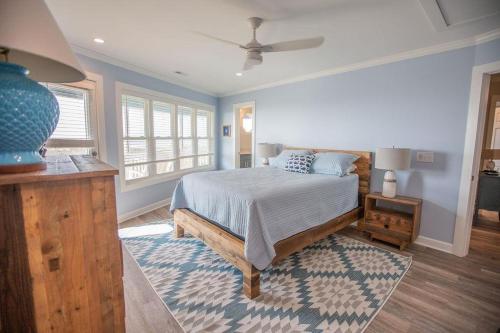 a bedroom with a bed and a blue at Three Girls in Holden Beach
