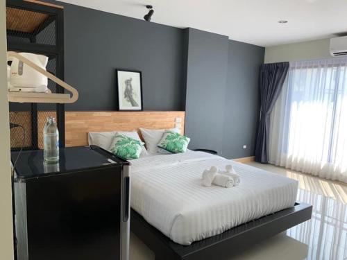 a bedroom with a bed with two teddy bears on it at Thanks​Pama​ in Bang Khen