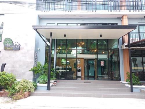 an entrance to a building with glass doors at Thanks​Pama​ in Bang Khen