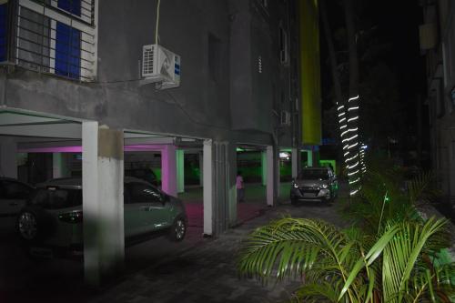 a parking garage at night with cars parked in it at HOTEL PURI GREENS in Puri