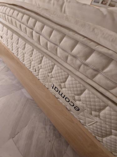 a mattress with the word rooid on it at Nefeli Seaside Apartments in Polykhrono