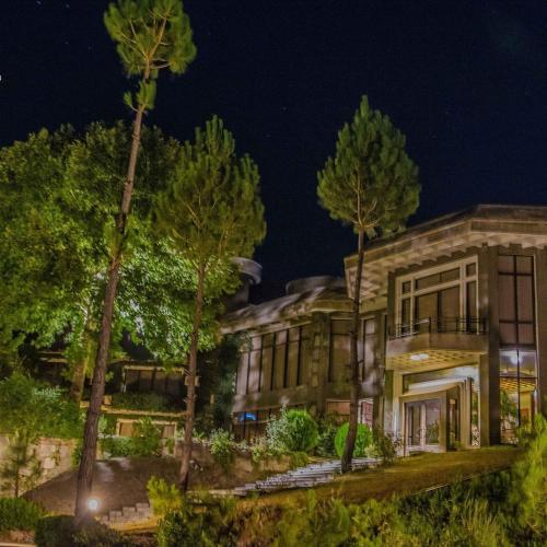 an exterior view of a building at night at Rock City Resort in Mingora