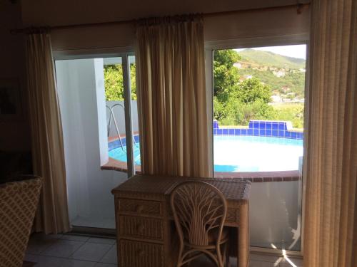 a living room with a view of a swimming pool at Fort Burt Hotel in Road Town