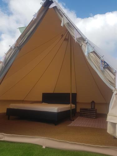 a large tent with a bed in it at Two Jays Farm in Norwich