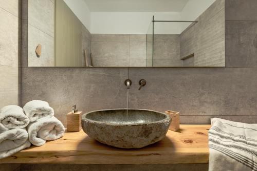 a bathroom with a large bowl sink on a wooden counter at The Olive Yard in Gythio