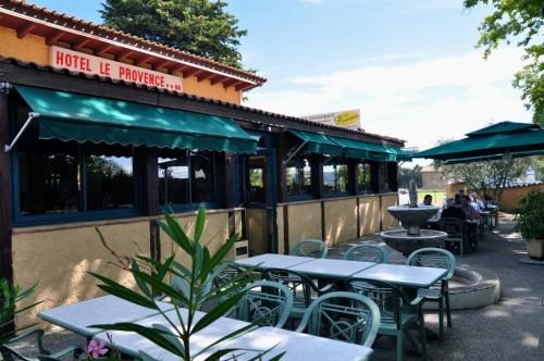 a restaurant with tables and chairs outside of it at Le Provence in Manosque