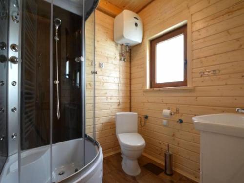 a bathroom with a toilet and a shower and a sink at Domki Gaja in Wysowa-Zdrój