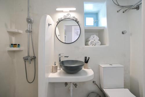 a bathroom with a bowl sink and a shower at Venetian Suites III in Naxos Chora