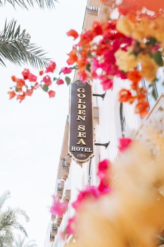 a sign for a hotel on the side of a building at Golden Sea Hotel in Ha Long