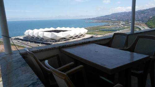 een tafel en stoelen op een balkon met een stadion bij Guesthaus Levent in Trabzon