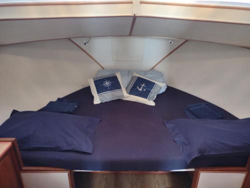 a bed in a boat with two books on it at BED&BOAT boatandholiday in Fano