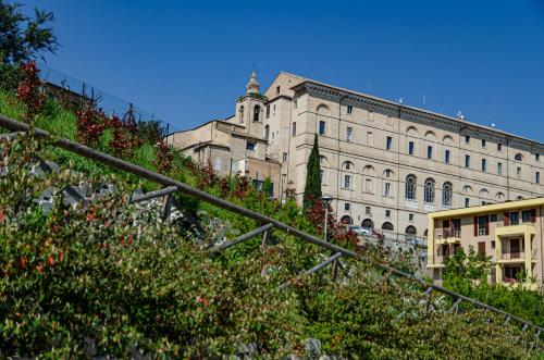 a large white building with a tree in front of it at Finestra sul mare in Recanati