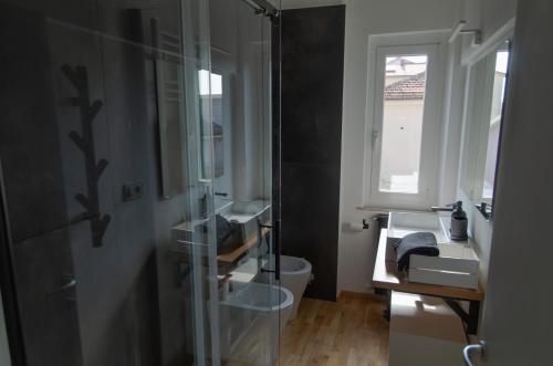 a bathroom with a sink and a toilet and a mirror at Finestra sul mare in Recanati