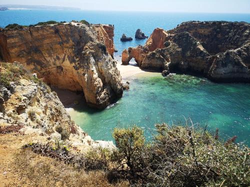 a view of a beach with rocks in the water at Regenbogen Properties - Salgados Vila das Lagoas in Albufeira