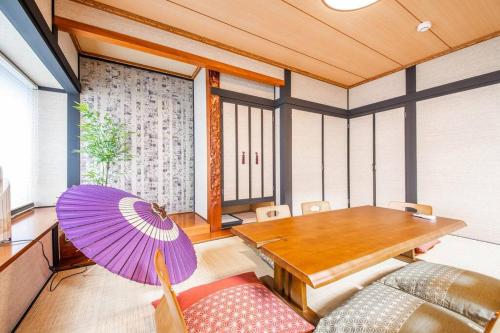 a room with a table and a purple umbrella at THE BEEHIVEⅠ in Sapporo