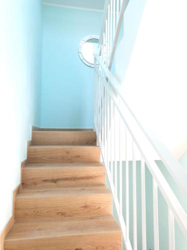 a staircase with wooden floors and a blue wall at The Sorabellas in Gaeta