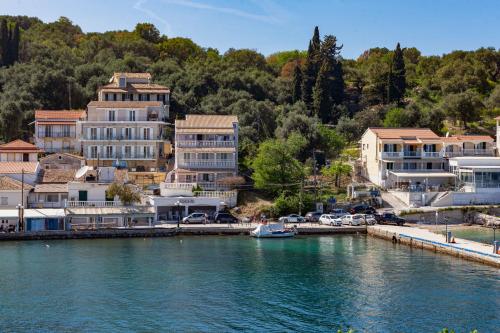 a group of buildings next to a body of water at Limani Apartments in Kassiopi