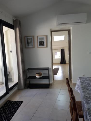 a dining room with a table and a mirror at Romantic Suite in Cabasse