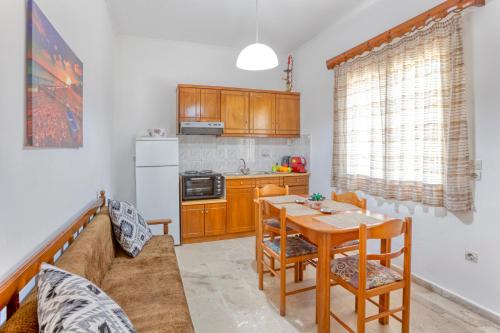 a kitchen with a table and a dining room at Limani Apartments in Kassiopi