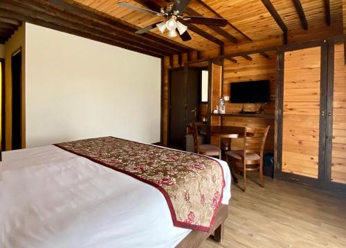 a bedroom with a bed and a dining room at Nassamat Boutique Hotel in Al Bārūk
