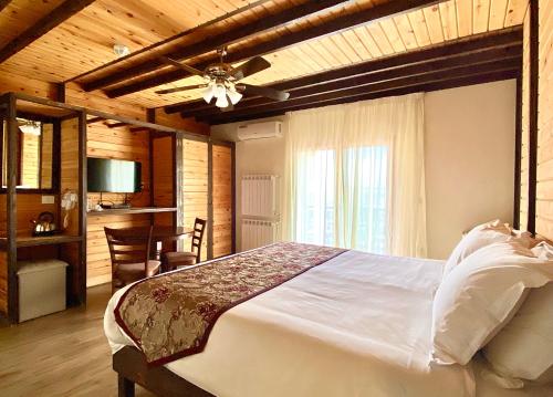 a bedroom with a bed and a ceiling fan at Nassamat Boutique Hotel in Al Bārūk
