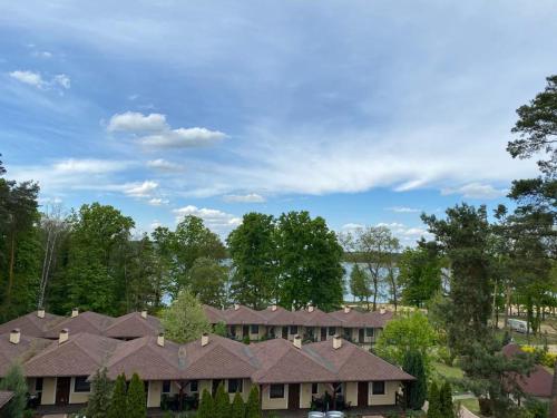 a row of houses with trees in the background at Hotel Vitalia in Boszkowo