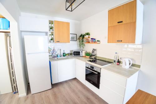 a kitchen with white cabinets and a stove top oven at Mandy's Place - By Soroka Medical Center and BGU in Beer Sheva