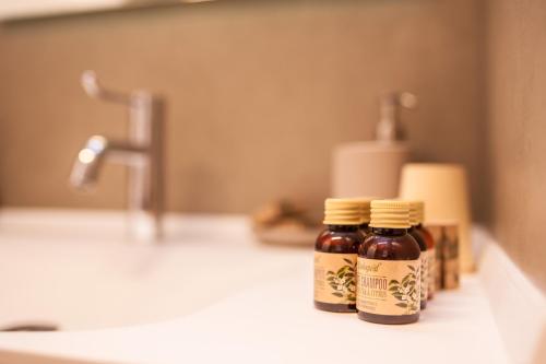 two bottles of honey sitting on a counter in a bathroom at Maison Lirà in Pren