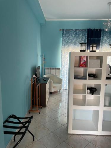 a room with a bedroom with a desk and a chair at Esmeralda Apartment in Palermo