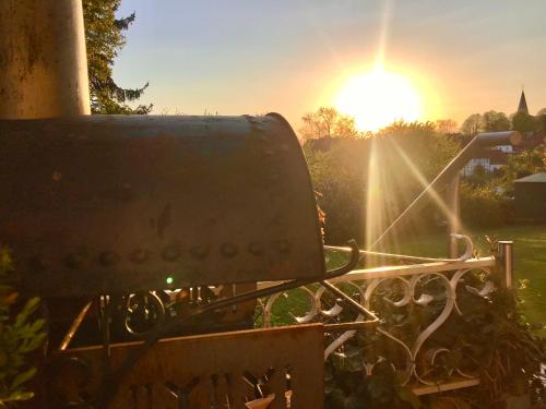 a bench with the sun setting in the background at Ferienwohnung Körbecke am Möhnesee in Möhnesee