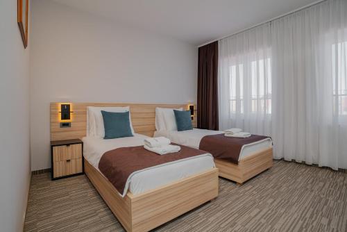 Postel nebo postele na pokoji v ubytování Maestro - Rooms & Restaurant