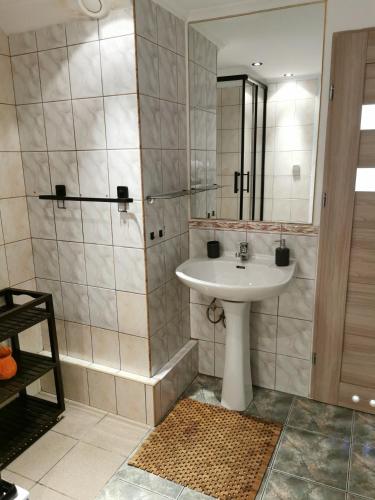 a bathroom with a sink and a mirror at MARINKA Grzybowo in Grzybowo