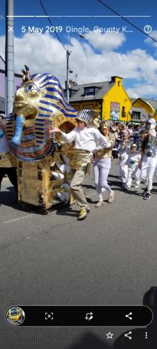 a group of people in a parade with a dinosaur costume at Baywatch Inn in Dingle