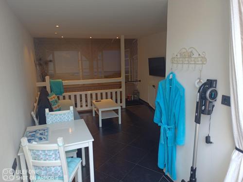 a room with a table and chairs and a room with at Zeelucht in Zandvoort