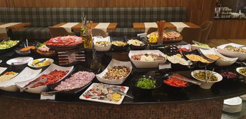 a table filled with lots of different dishes of food at Free SPA в Св. Иван Рилски - Сладък дом сред лукс in Bansko