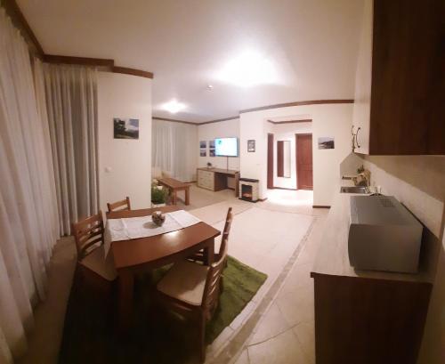 a kitchen and living room with a table and chairs at Free SPA в Св. Иван Рилски - Сладък дом сред лукс in Bansko