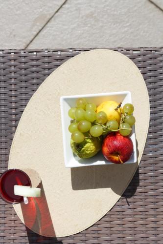 a plate of fruit and vegetables on a table at Mercure Salvador Pituba in Salvador