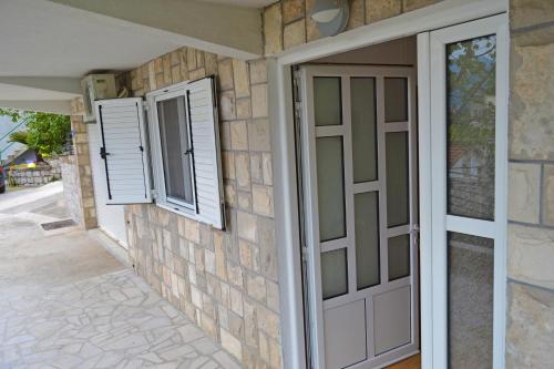 a pair of windows and a door on a house at Tivat Apartments in Tivat