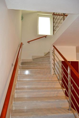 a staircase in a house with a window at Tivat Apartments in Tivat