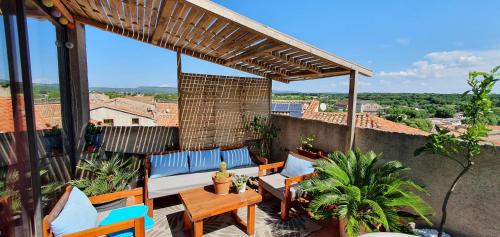 a patio with chairs and tables on a balcony at Joshroom in Caux