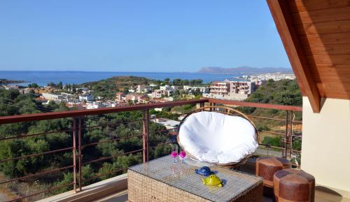 a balcony with a table and a view of a city at Anestis Ioanna Villa in Daratso