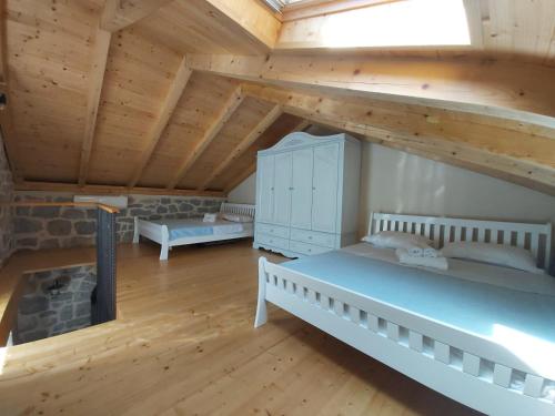 a attic room with two beds and a fireplace at Casa Vecchia in Kotor