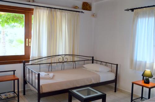 a bedroom with a bed and a window at Anestis Ioanna Villa in Daratso