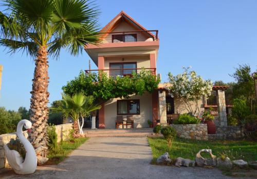 a house with a palm tree and a swan at Anestis Ioanna Villa in Daratso
