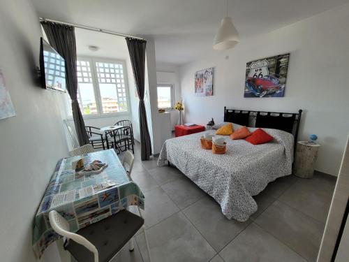 リニャーノ・サッビアドーロにあるRosato 2 Sea View Apartmentのベッドルーム(ベッド1台、テーブル付)
