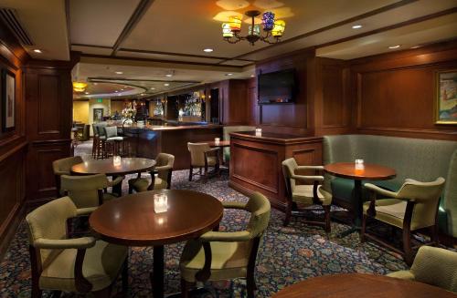 a restaurant with tables and chairs and a bar at Warwick Seattle in Seattle