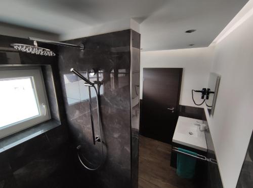 a bathroom with a shower and a sink at Ferienwohnung am Wiedenberg in Arnsberg