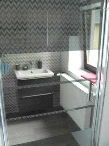 a bathroom with a sink and a mirror at Apartmán U paní Věrky in Sloup